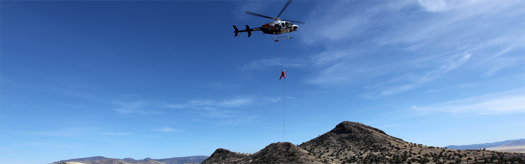 Backcountry Unit hanging from a helicopter